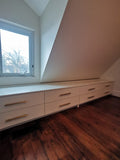 A 10 ft long custom build dresser unit for an awkward space, boast 8 soft close drawers with under mount slides . A sleek and streamlined white exterior  with recessed kick.   Making the space equal part functional and chic!!