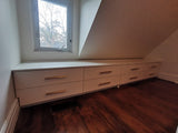 A 10 ft long custom build dresser unit for an awkward space, boast 8 soft close drawers with under mount slides . A sleek and streamlined white exterior  with recessed kick.   Making the space equal part functional and chic!!
