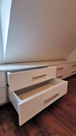 A 10 ft long custom build dresser unit for an awkward space, boast 8 soft close drawers with under mount slides . A sleek and streamlined white exterior  with recessed kick.   Making the space equal part functional and chic!!