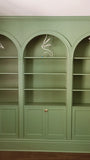 To restore a Victorian house back to its original splendor the bookshelf  was designed with three architecturalarches with carved half columns, open adjustable shelves on top and double doors at the bottom.     The crown molding on top and the original restored baseboard at the bottom gives it a complete builtin aesthetic!