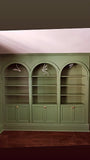 To restore a Victorian house back to its original splendor the bookshelf  was designed with three architecturalarches with carved half columns, open adjustable shelves on top and double doors at the bottom.     The crown molding on top and the original restored baseboard at the bottom gives it a complete builtin aesthetic!