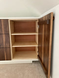 An absolutely spectacular 13 ft long MCM inspired dresser / bedroom unit. Custom build unit boast 9 soft close drawers with under mount slides and 2 door panels on either ends. Which can easily handle all storage needs with ease and still look splendid! Fronts built from beautiful walnut with exceptional grain pattern throughout. The vintage pulls and shell shape handles add a time less feel. A sleek and streamlined white exterior with recessed kick giving it the floating look