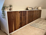An absolutely spectacular 13 ft long MCM inspired dresser / bedroom unit.  Custom build unit boast 9 soft close drawers with under mount slides and 2 door panels on either ends. Which can easily handle all  storage needs with ease and still look splendid!  Fronts built from beautiful walnut  with exceptional grain pattern throughout.  The vintage pulls and shell shape handles add a time less feel.  A sleek and streamlined white exterior  with recessed kick giving it the  floating look 