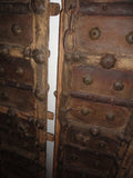 Rajasthani antique wooden doors with iron fittings and details.  The doors are rustic, weather beaten with great patina & heavy.  Can be hanged on the wall as a feature display or used as functional door panels  Approximately 17”wide x 80” high / each