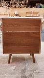 Custom build MCM inspired 30" solid walnut wood vanity​ cabinet​, featuring one deep soft close inset drawer ​, tapered wood legs, quartz countertop  with gray veins and a ceramic sink. 
