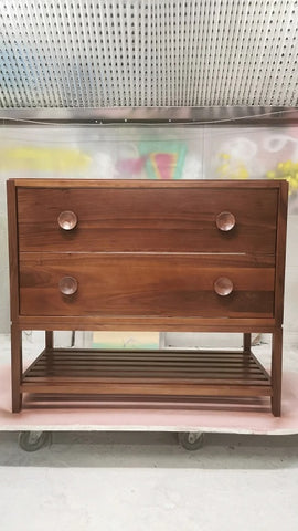 The hand-crafted solid walnut wood bathroom vanity boasts  2 deep soft close drawers and a storage shelf.  A unique & sleek design featuring tapered legs, 1/4" reveal at the top,  & inset drawers which are set back 1/4" to reveal the frame.  The concave walnut wood pulls/knob gives the cabinet a retro / mid-century feel