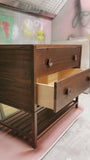 The hand-crafted solid walnut wood bathroom vanity boasts  2 deep soft close drawers and a storage shelf.  A unique & sleek design featuring tapered legs, 1/4" reveal at the top,  & inset drawers which are set back 1/4" to reveal the frame.  The concave walnut wood pulls/knob gives the cabinet a retro / mid-century feel