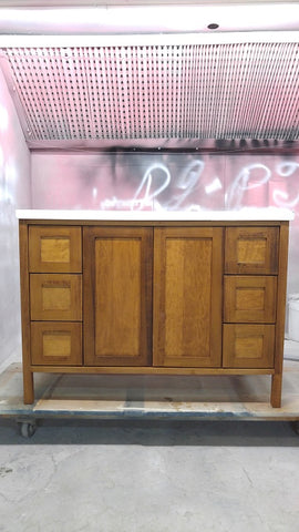 The 46'' bathroom vanity add style and storage, constructed from solid poplar wood & featuring shaker style door and drawer panels finished in golden oak stain and a white quartz counter top with an under mount ceramic sink.  Six soft close drawers along the sides and two doors that open to reveal extra shelf space, there's plenty of room to tuck away towels and toiletries.