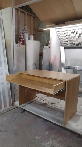 Custom build desk to fit a home studio with limited space. Its modern design sports a slide-out for keyboard with a spacious top to position computer monitor and studio monitors. 