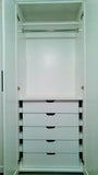 A double-tiered hanging system for folded pants, skirts, jackets on one side and combination of drawers, shelving and hanging rod on the other side, coupled with shaker style doors give this bedroom custom built closet a contemporary & classic style with all the storage one may  need.  