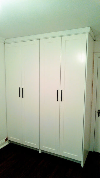 A double-tiered hanging system for folded pant​s, ​​skirts, jackets ​on one side and combination of drawers, shelving and ​​hanging rod on the other side, coupled with shaker style doors give this bedroom custom built closet a contemporary & classic style with all the storage one may  need. 