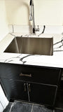  ​ There’s no reason your laundry room shouldn’t be as beautiful as the rest of your home.  An outdated laundry room  was transformed into a bold  & sophisticated space with Asian inspired black custom cabinets & brass pulls.  A gorgeous sink cabinet with  black veined quartz counter top and extra deep stainless steel sink.  Wall cabinets provide plenty of shelf space and  hanging rod.