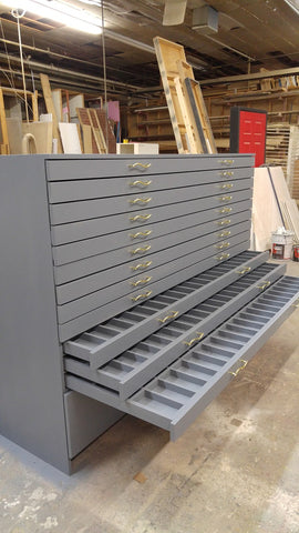 The existing drawer unit, which was being used on a very busy shop floor of a wholesale clothing company,  was falling apart even after continually replacing the drawer rails. (see before & after)  We designed an extra wide  & deep drawer cabinet which not only has 12 functional soft close drawers but is sturdy enough to  take wear & tear of a busy work shop . Each drawer is able to accommodate 70 slots for labels. 80" Wide x 30" Deep x 40" ht