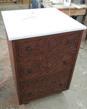 An absolutely gorgeous one of a kind  cabinet with hand carved rose wood drawer panels - converted into a bathroom vanity with a white quartz top and oval ceramic sink.  - 24" x 24" x 35" (ht)