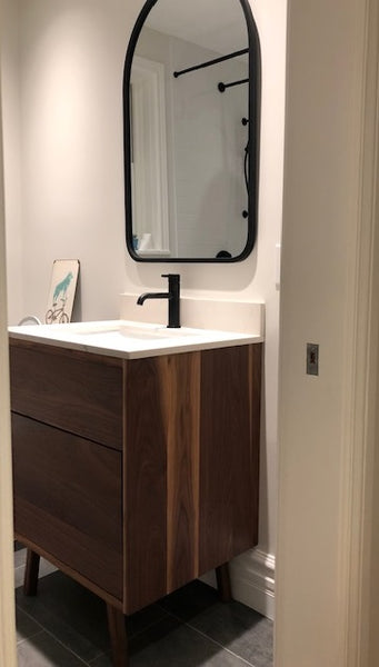 Custom build MCM inspired 30" solid walnut wood vanity​ cabinet​, featuring one deep soft close inset drawer ​, tapered wood legs, quartz countertop  with gray veins and a ceramic sink. 
