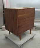 Custom build  MCM inspired 30" solid walnut wood vanity​ cabinet​, featuring 2 ​soft closing drawer ​and​ solid wood tapered legs. ​ ​  An elegant addition to any bath space, unique and beautiful texture​d walnut wood makes ​​bathroom luxurious​ly stunning.  -Custom build  -Built from solid walnut wood  -Tapered legs  -Soft closing drawers ​  - 30" x 22 " x 33" (ht)