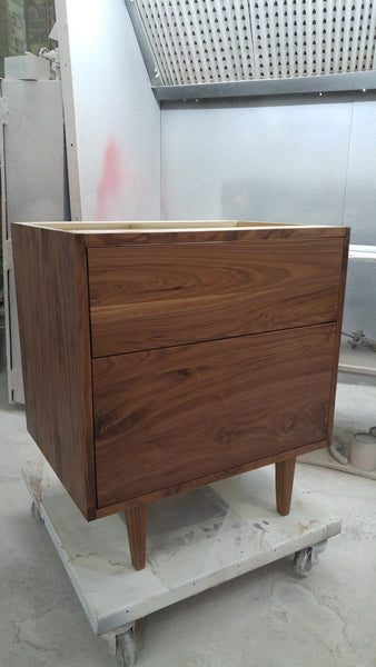 Custom build MCM inspired 30" solid walnut wood vanity​ cabinet​, featuring 2 ​soft close inset drawers ​and​ solid wood tapered legs. ​ ​Gold handles add timeless touch to the cabinet, an elegant addition to any bathroom, beautiful walnut wood makes ​​bathroom ​luxurious​ and stunning.